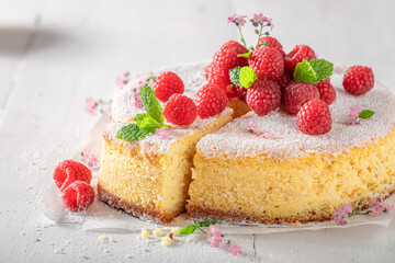 Tasty and fresh cheesecake with berries and powdered sugar.