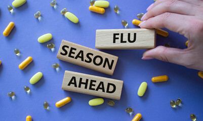Flu Season Ahead symbol. Concept word Flu Season Ahead on wooden blocks. Doctor hand. Beautiful...