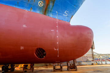 Cargo vessel in dry dock on ship repairing yard. Bow thruster. © Alexey Seafarer