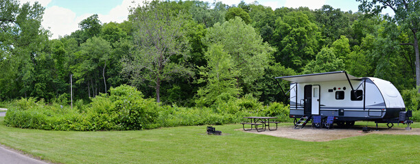 Travel trailer camping in the woods at Mississippi Palisades State Park, Illinois