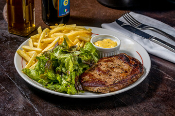 grilled steak with potatoes and vegetables