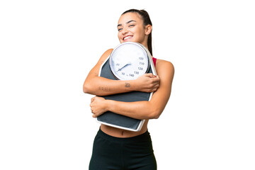 Young beauty woman over isolated chroma key background with weighing machine