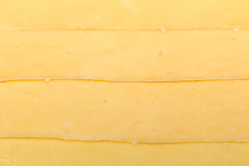 cheese background. overlapping slices of cheese. cheese details. cheese texture.