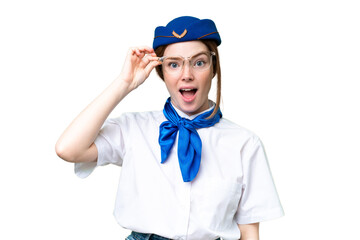 Airplane stewardess over isolated chroma key background with glasses and surprised