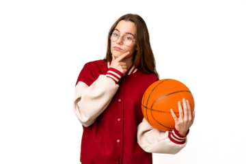 Teenager girl playing basketball over isolated chroma key background thinking
