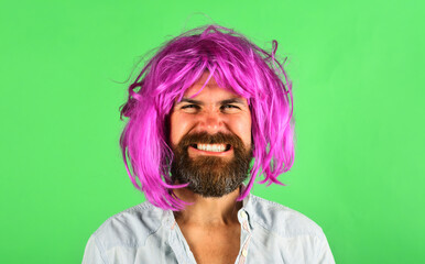Funny bearded man in pink wig. Handsome guy with beard, mustache in colored wig. Attractive bearded...