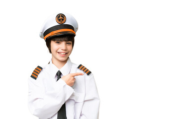Little girl as a Airplane pilot over isolated chroma key background pointing to the side to present a product