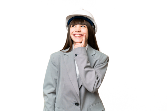 Little girl playing as a architect with helmet and holding blueprints over isolated background thinking an idea while looking up