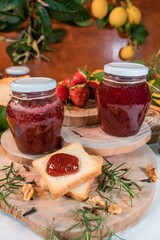 Few Slices of bread with assorted jams, next to jam jars