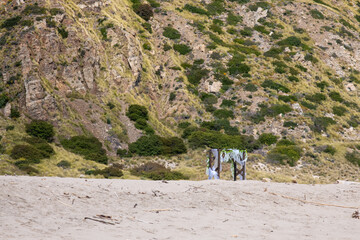 Wedding arch decorated with flowers on the beach