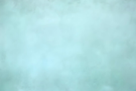 Pastel mint color blurred background. Abstract portrait backdrop for studio. Empty textured wall.