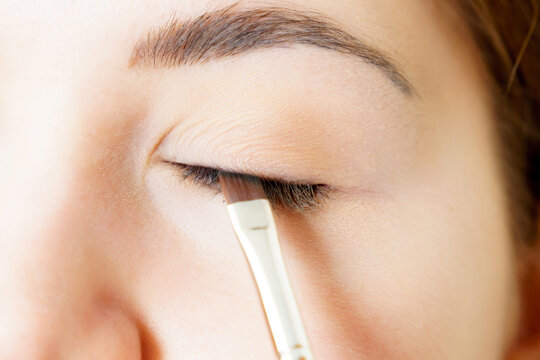 Makeup artist applying eye make up