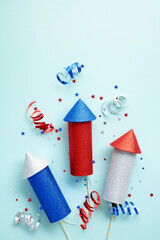4th Of July fireworks with confetti on pastel blue background. Happy Independence Day USA concept.