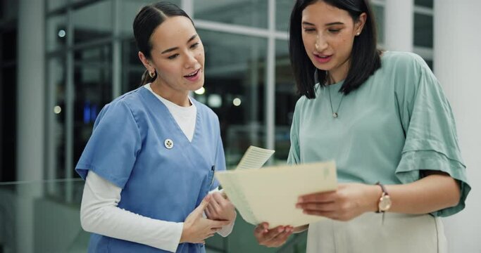 Doctor, nurse and handshake for teamwork with paperwork in hospital for healthcare as professional in ER. Female people, talking and collaboration in meeting or debrief in clinic with medical record