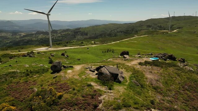 Aerial video above Casa do Penedo Boulder House in Fafe, Portugal