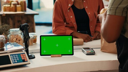 Tablet running display with blank greenscreen at checkout, showing isolated chromakey layout in...
