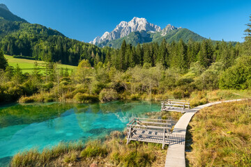 Zelenci Springs with the Julian Alps at background during summer in Slovenia
