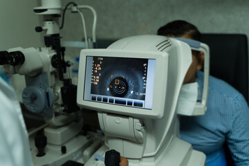 Ophthalmologist using state-of-the-art diagnostic tools to conduct a thorough eye examination on a patient at a clinic