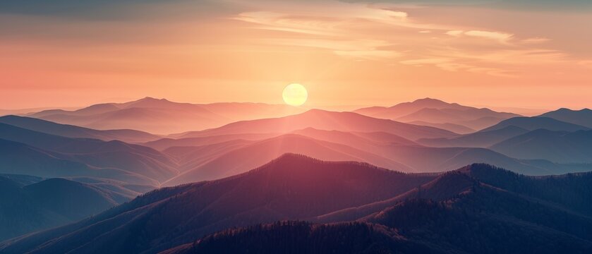 Breathtaking view of sunrise over misty mountains with colorful sky, creating a tranquil and serene landscape scene.