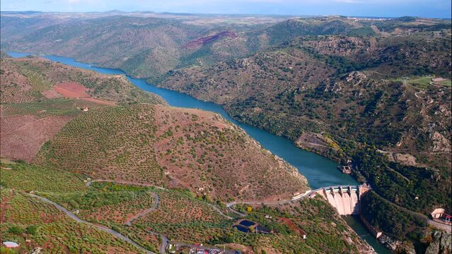 Time lapse of clouds moving over mountain and Douro river with spanish Saucelle Dam. Border between Portugal and Spain. National Parks. View from portuguese Penedo Durao lookout.