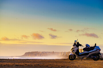 Scooter on beach at sunrise