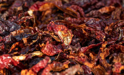 Top view of pile of dried red hot chili peppers. Hot peppers drying in the sun, showcasing texture and spicy ingredient concept.