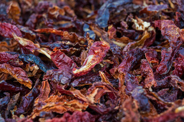 Top view of pile of dried red hot chili peppers. Hot peppers drying in the sun, showcasing texture and spicy ingredient concept.
