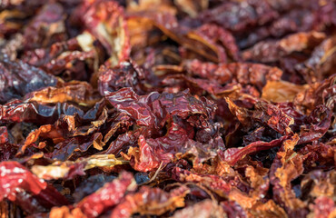 Top view of pile of dried red hot chili peppers. Hot peppers drying in the sun, showcasing texture and spicy ingredient concept.