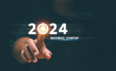 Business startup concept. Businessman touch turn on icon for start new business on 2024. Planning...