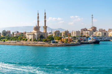 Badr Mosque with dome and minarets along the south entrance of the Suez Canal at the city of Port...