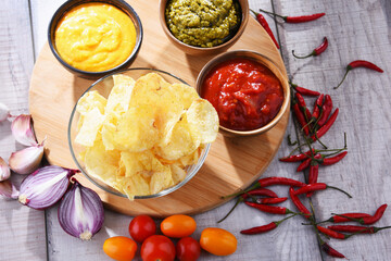 Composition with bowl of potato chips.