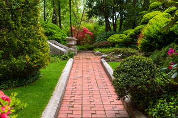 Brick pathway through a serene house garden in Boston, MA, USA