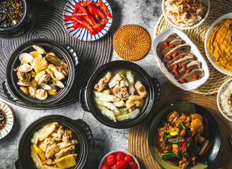 Pineapple Bitter Melon Chicken, Peeled Chili Clam Chicken, Braised chicken with soy sauce, rice, Pickled plum tomatoes, Fried scallions eggs omelet served isolated top view of assorted taiwan food