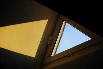 Sky through a window with a yellow triangle in the middle