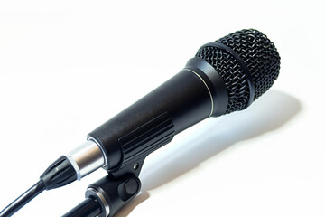 A microphone is shown with a black cord