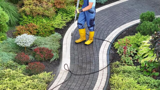Power Washing Concrete Bricks Paths in a Backyard Garden