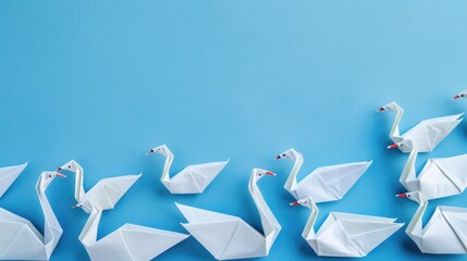 Innovative leadership idea portrayed with paper origami swans against a blue backdrop