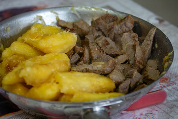 Traditional sun-dried meat with cooked cassava and bottled butter