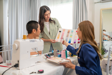 Obraz premium Fashion design concept, young stylish woman fashion designer working in studio office, small business owner creating new fashion design cloth in atelier.