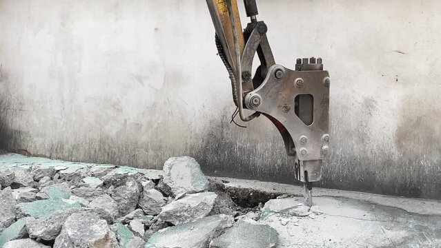 Closeup bucket of backhoe digging the soil at construction site. Crawler excavator digging on demolition site. Excavating machine. Earth moving equipment. Excavation vehicle. Construction business.