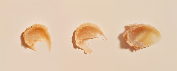 Three cosmetic scrub texture swatches. Exfoliating cream with abrasive sugar or salt particles.