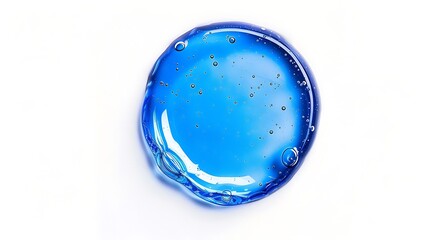 Perfectly round oil drop, vibrant blue, against a stark white background.