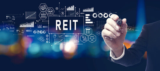 REIT - Real Estate Investment Trust theme with businessman in a city at night