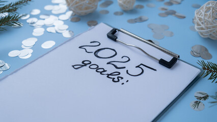 Handwritten 2025 GOALS new year resolutions aims goals on paper notepad. Preparation for New Year....