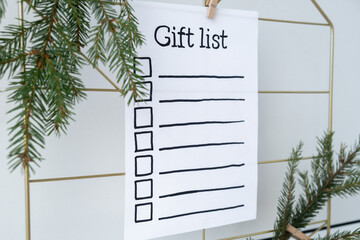 Preparation for winter holidays. GIFT LIST text on paper note. Celebration gifts and presents...