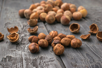 Hazelnuts Scattered on Rustic Wooden Table with Opened Shells