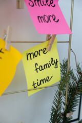 MORE FAMILY TIME goal on Vision board with new year resolutions aims on sticky notes. Preparation...