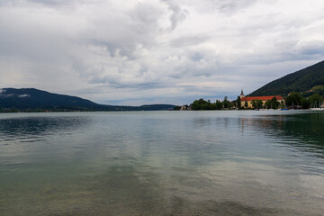 Panorama view of lake Tegernsee with marina, church and mountains in Bavaria, Germany