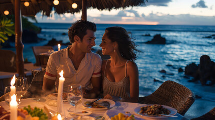A couple is sitting at a table by the ocean