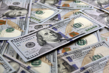 100 Dollar Bills USA Banknotes Scattered Ben Franklin Shadow Angled View